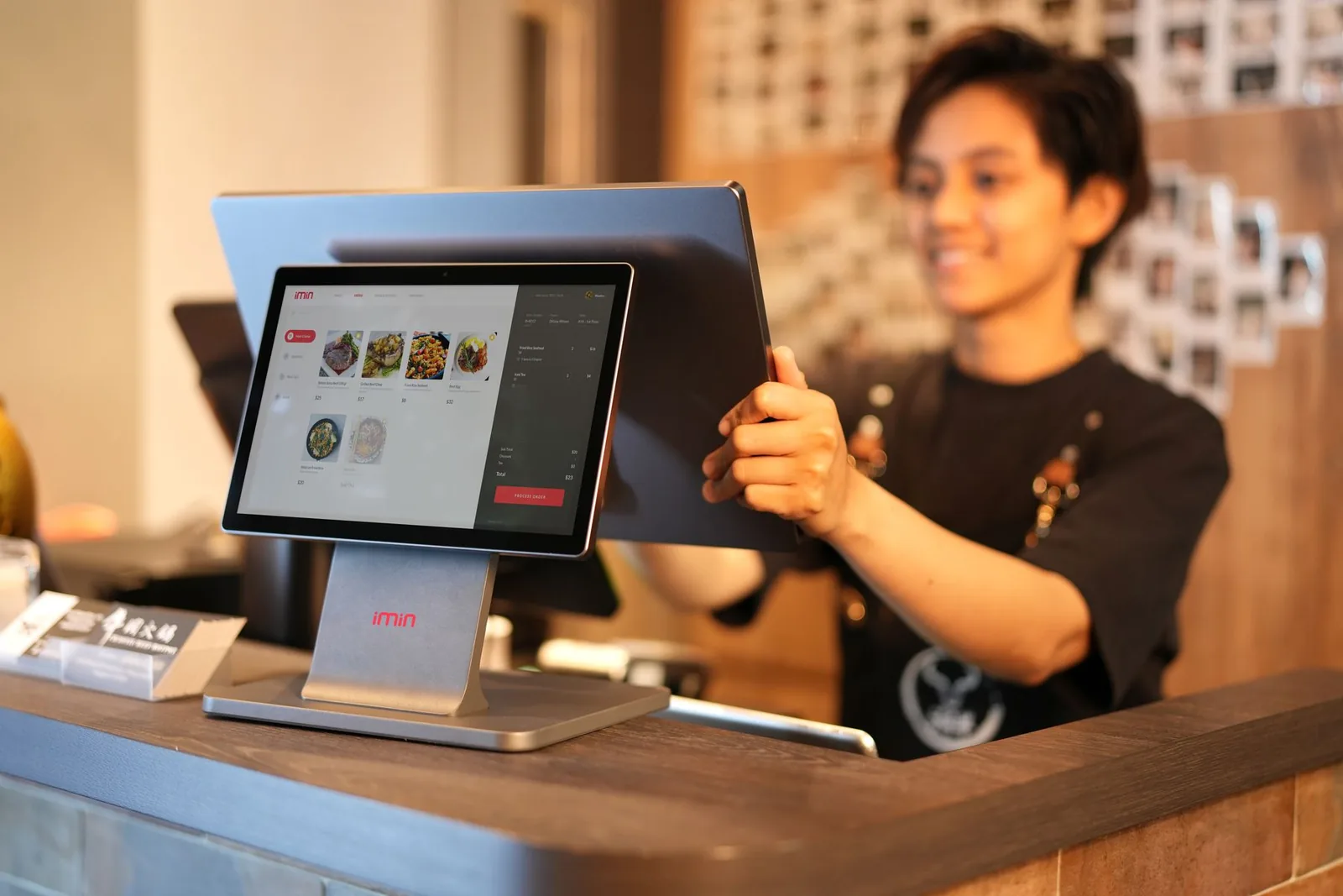 Cassiera che usa un punto cassa touchscreen in un negozio